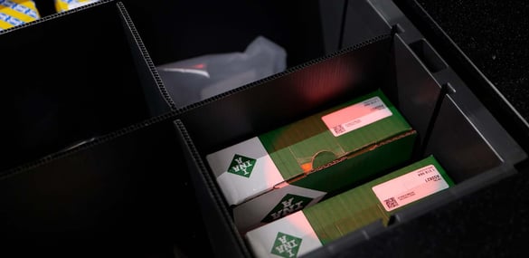 An AutoStore Bin with a pick light indicating inventory