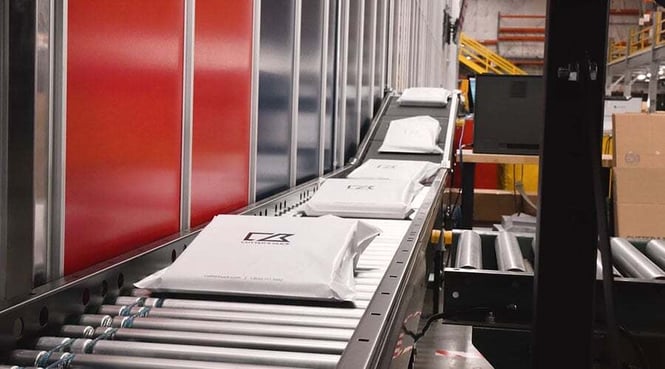 Cutter & Buck orders travel along conveyor by the AutoStore