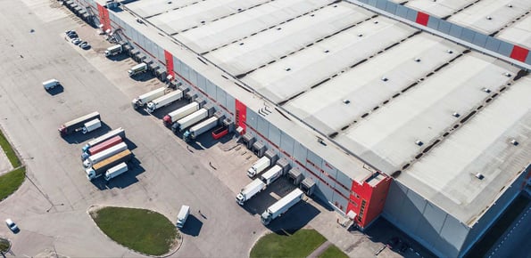 An overhead picture of a warehouse with truck movement