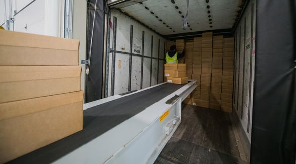 Sealed boxes on conveyor for loading on truck