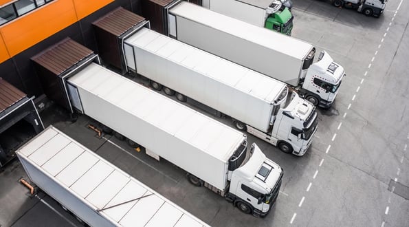 Trucks backed up to loading docks at a warehouse