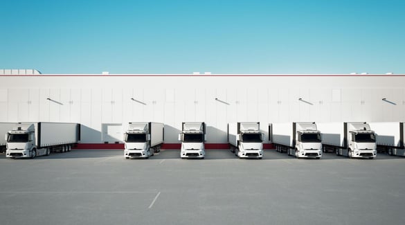 Trucks backed up to loading docks at warehouse