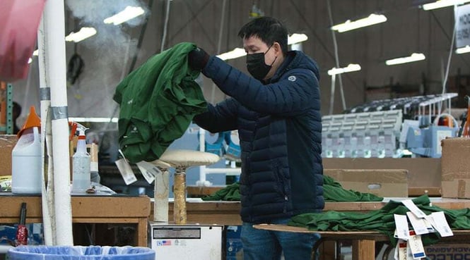 A worker sorts clothing at Cutter &amp; Buck