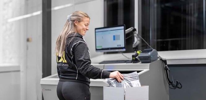 A worker picks inventory for fulfillment from a FusionPort