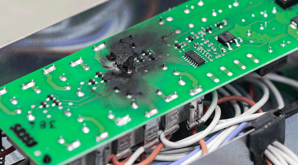 A circuit board showing burn damage
