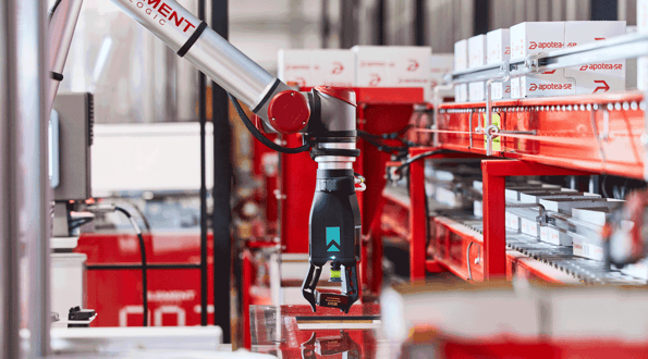 A robotic arm picks inventory for fulfillment