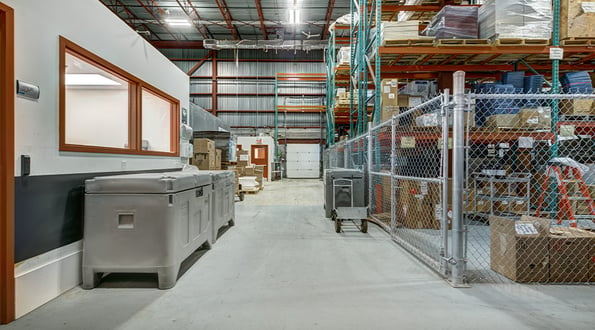 A warehouse with an office and shelving