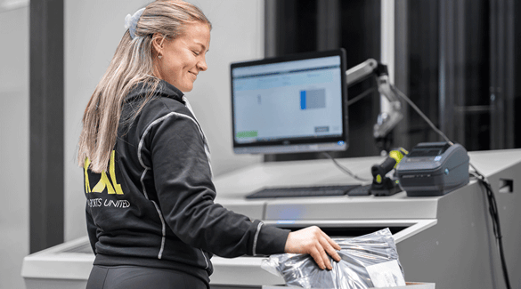 A worker pulling inventory at a FusionPort workstation at XXL