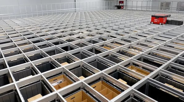 A R5 Robot moving Bins at top of Grid