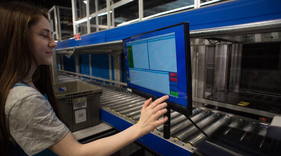 A worker processes through orders for fulfillment