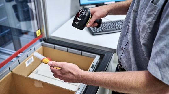 Worker scans items at an AutoStore workstation
