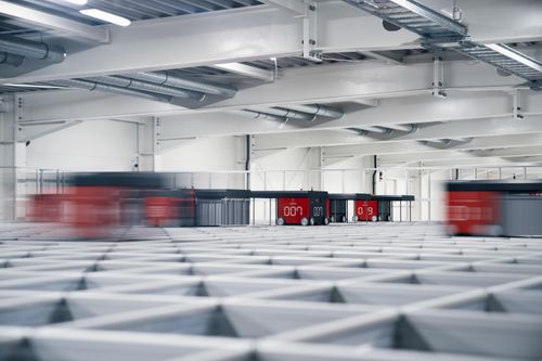AutoStore R5 Robots moving on grey background