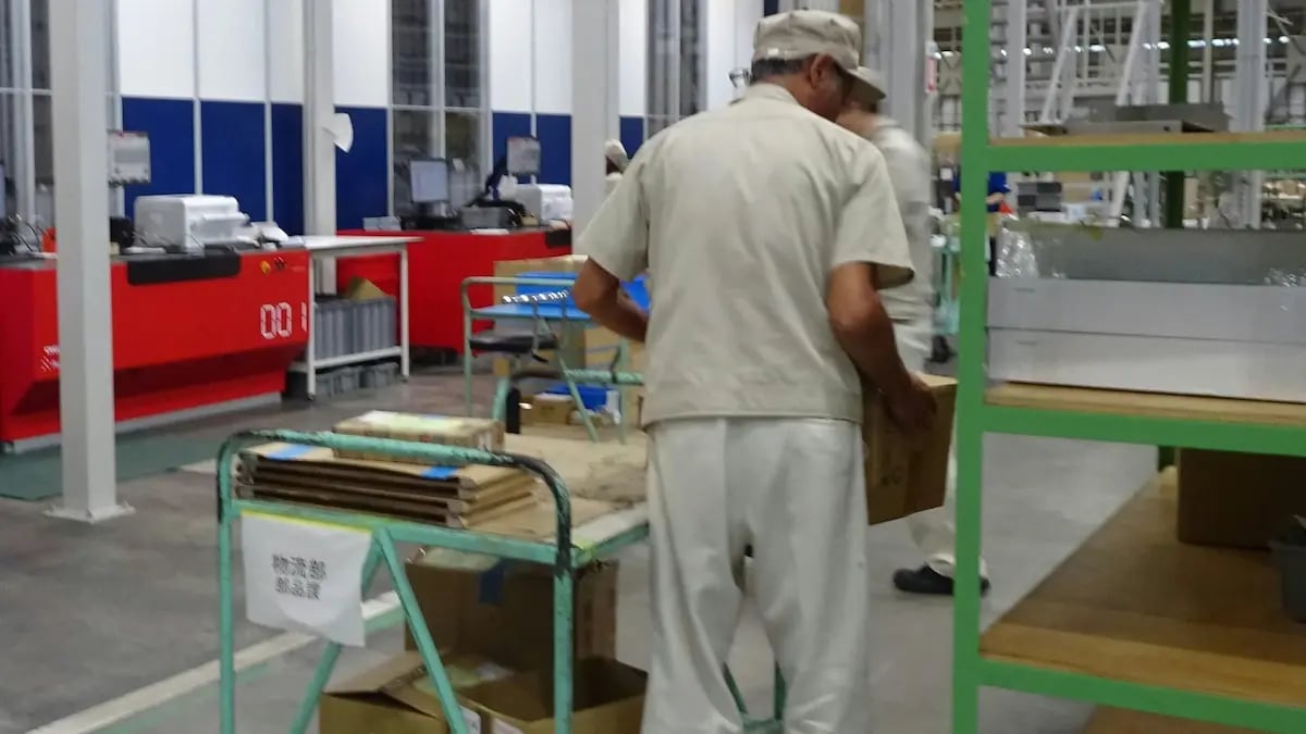 Workers at the RHEON warehouse prepare orders. The AutoStore installaiton has saved 67% space in their existing location. 