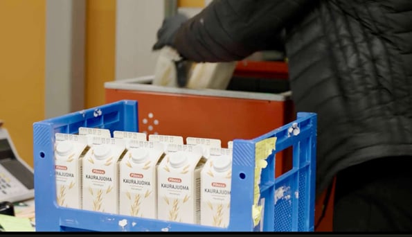 A worker restocks an AutoStore Bin