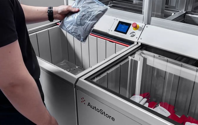 A worker selects items from an AutoStore workstation