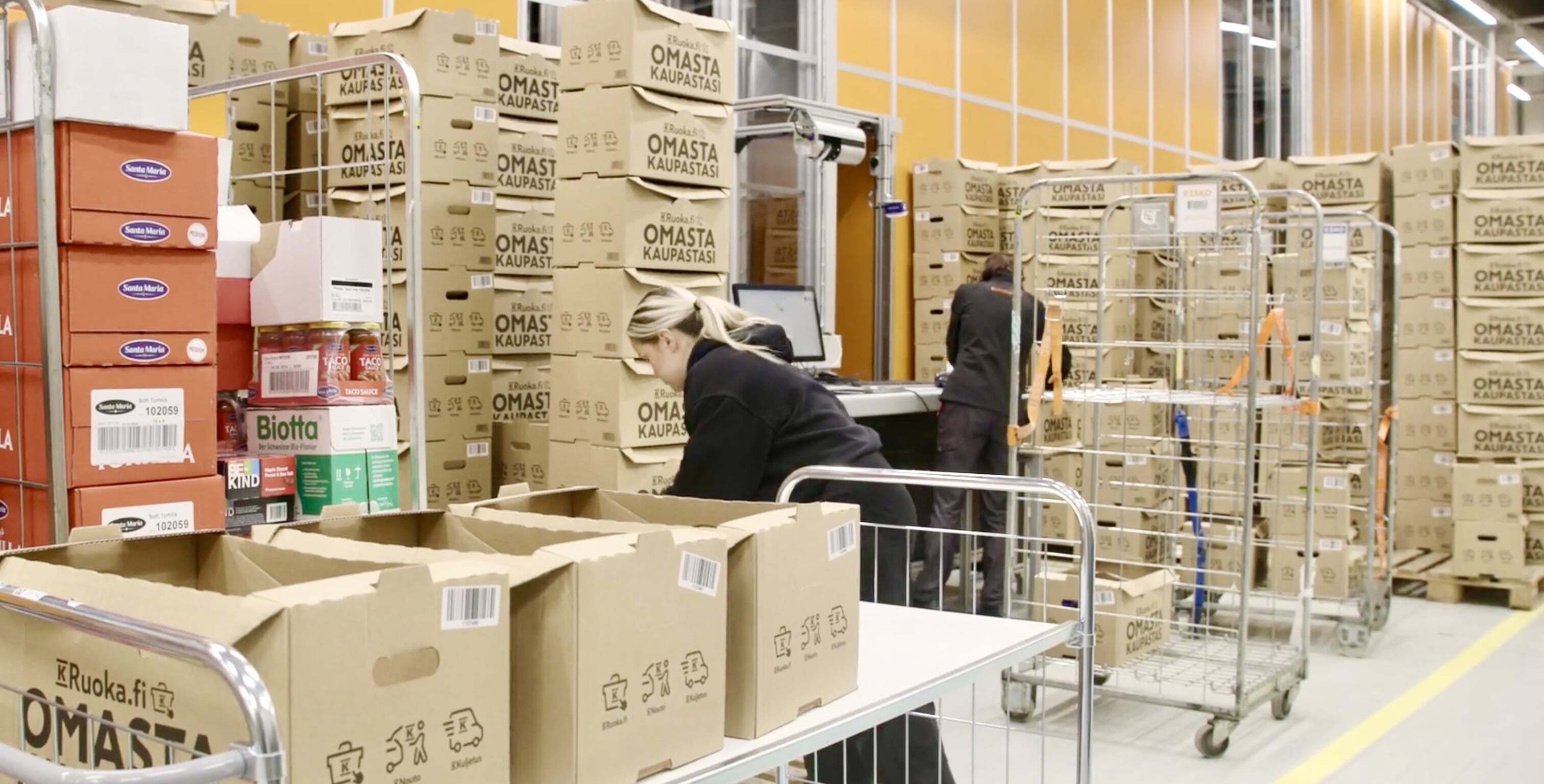 Workers organize boxes at Kesko warehouse