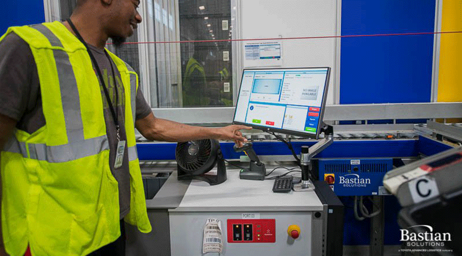 A Best Buy employee picking goods from an AutoStore Port
