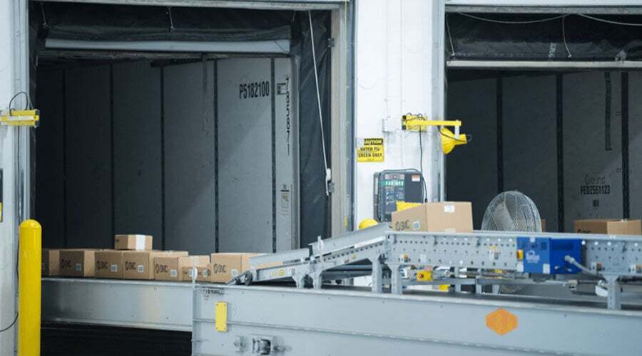 A conveyor carrying boxed goods to a loading dock at SMC in Indiana. Image.