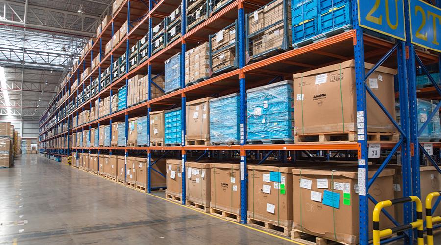 Pallets of inventory arranged on storage racks. Image.